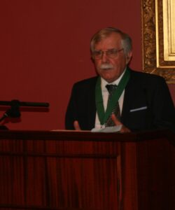 Poet Rodger Martin reading at a podium