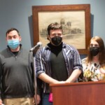 A panoramic image of the readers at the Rain Poets Reading.
Photo by Robert Steele.